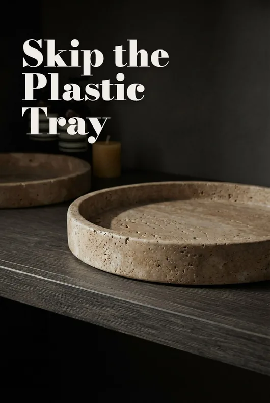 Round stone tray on a dark vanity
